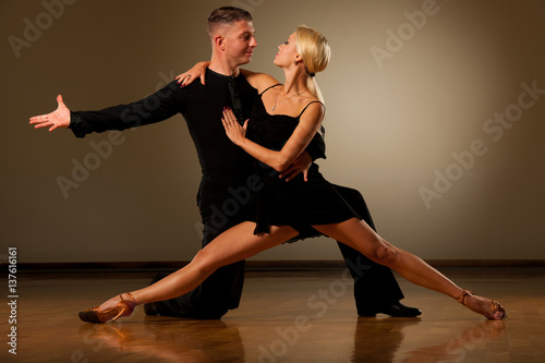 Beautiful ballroom couple preforming their pasonate exhibition dance