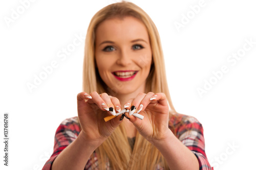 Young woman breaks cigarette as gesture for quit smoking isolated over white