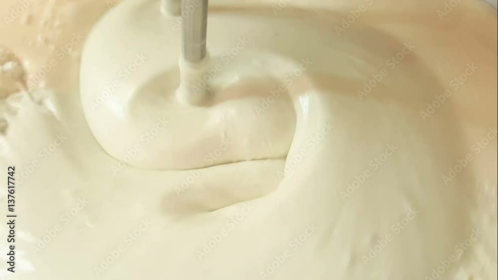 Close up of twist white cream spining add more flour and mixing color in the blow Close up of twist white cream spining add more flour and mixing color in the blow
