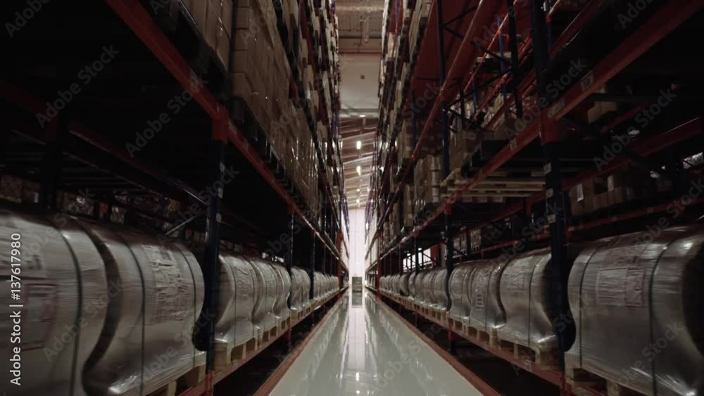 Camera moving between palettes with ordered goods and materials at warehouse. Camera moving between palettes with ordered goods and materials at warehouse.