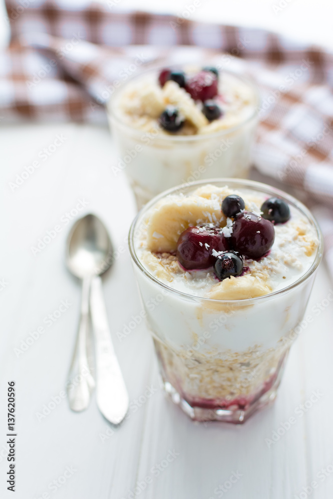 Healthy breakfast. Oatmeal with bananas, berries and honey