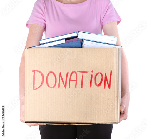 Woman holding donation box with books on white background
