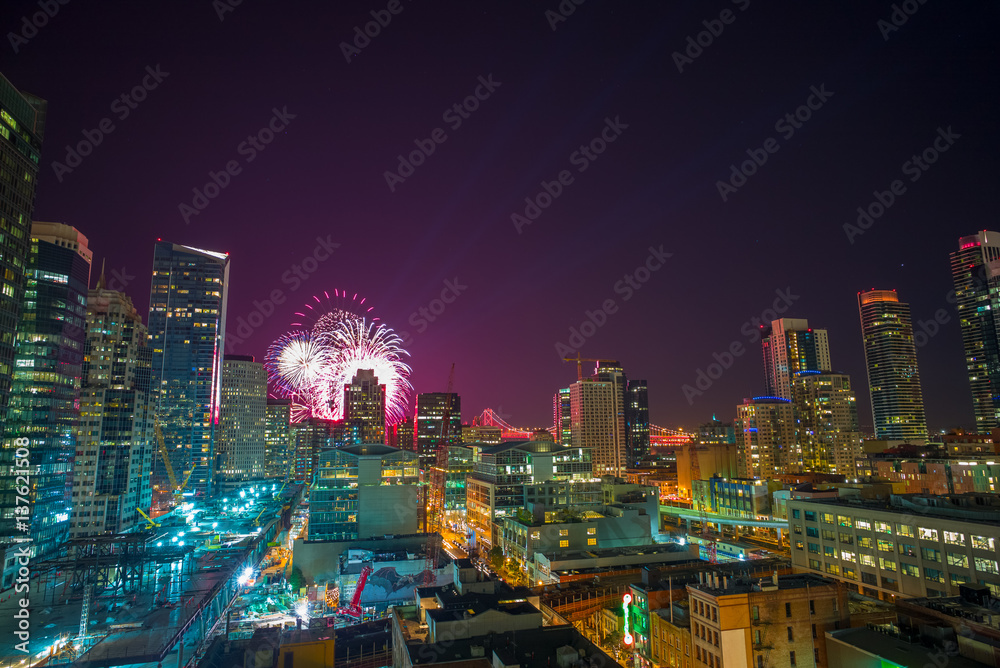 Fireworks over downtown San Francisco, California, USA.  Cityscape at Night.  Transbay terminal construction in the foreground.