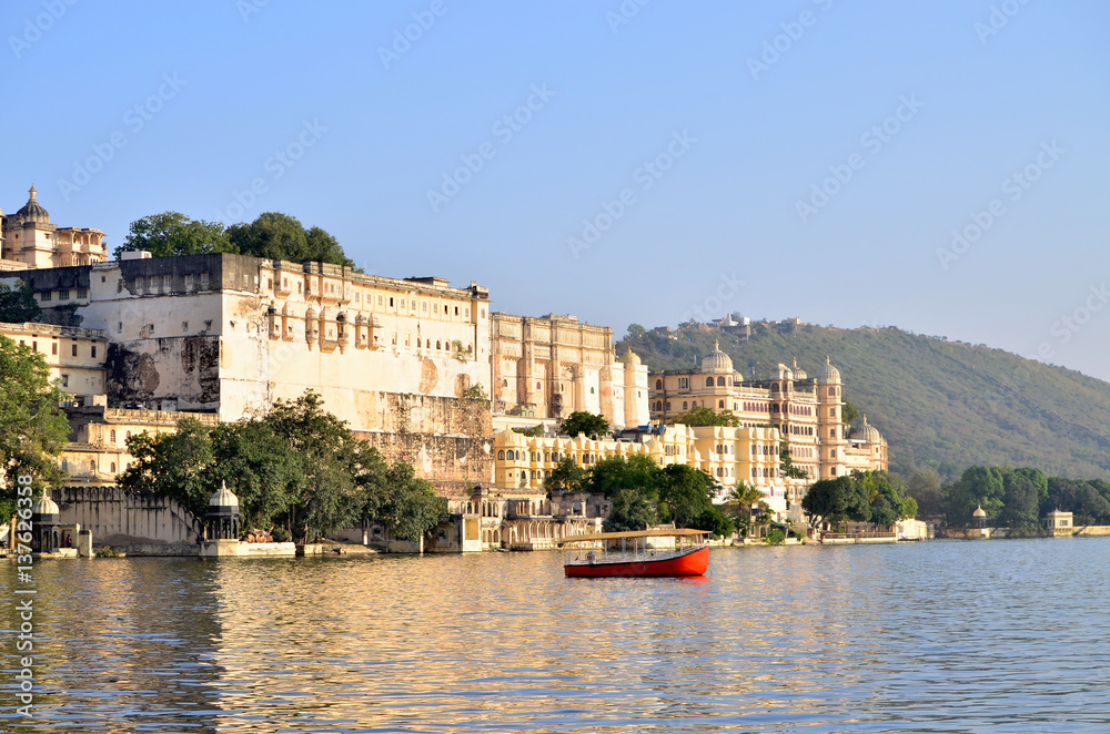 Beautiful landscape of the city on water at sunset in India Udaipur
