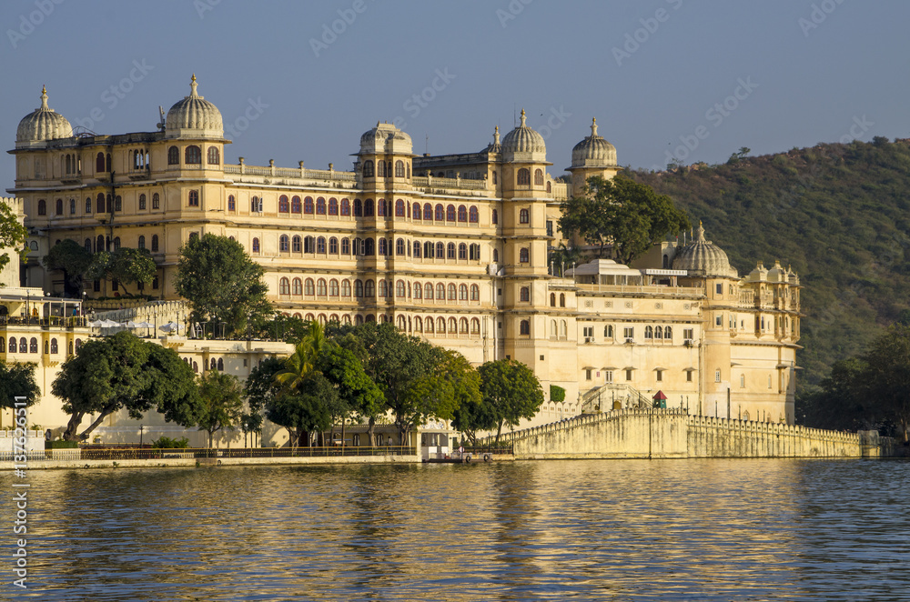 Beautiful landscape of the city on water at sunset in India Udaipur
