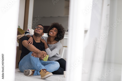 African American couple relaxing in new house