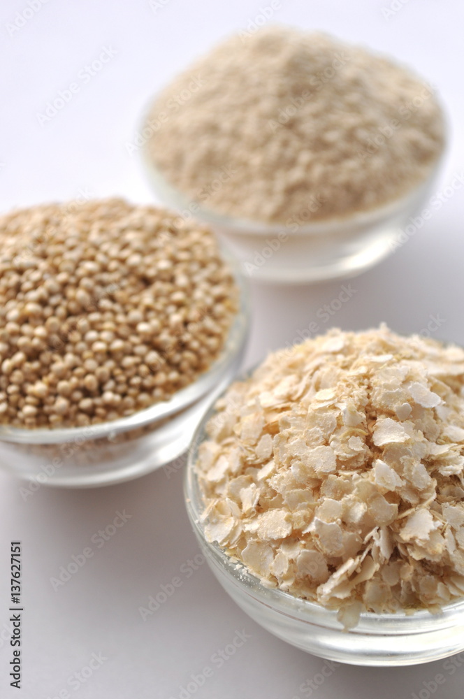 Quinoa in three forms - flour, flakes and grain. Alternative gluten-free grain. Isolated on white Quinoa in three forms - flour, flakes and grain. Alternative gluten-free grain. Isolated on white