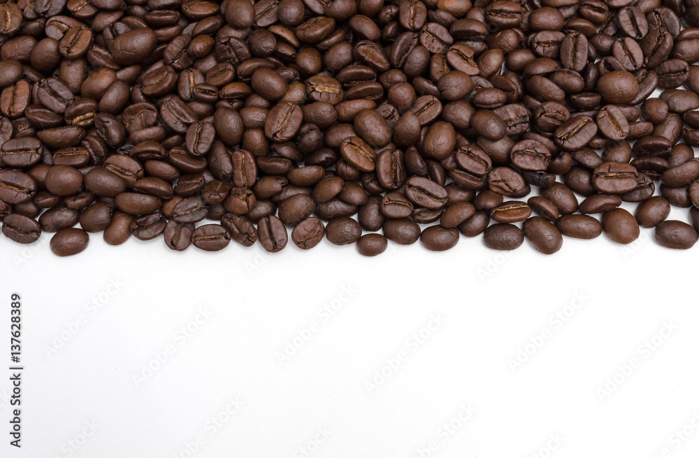 Roasted coffee beans on white.