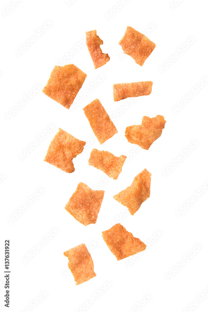 Falling sliced sheets of crispy pork on white background. Falling sliced sheets of crispy pork on white background.