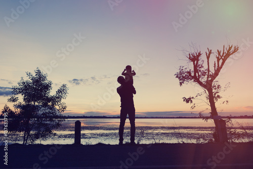 Silhouettes. Father and son playing together
