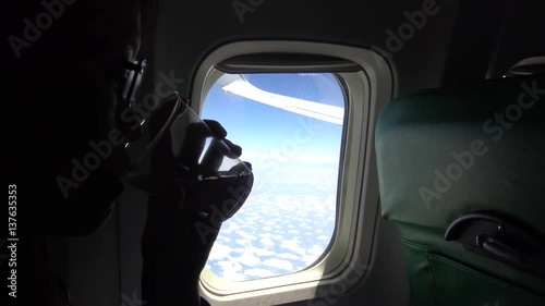 Wallpaper Mural 4K Asian Young beautiful girl look out of airplane window and drinking water-Dan Torontodigital.ca