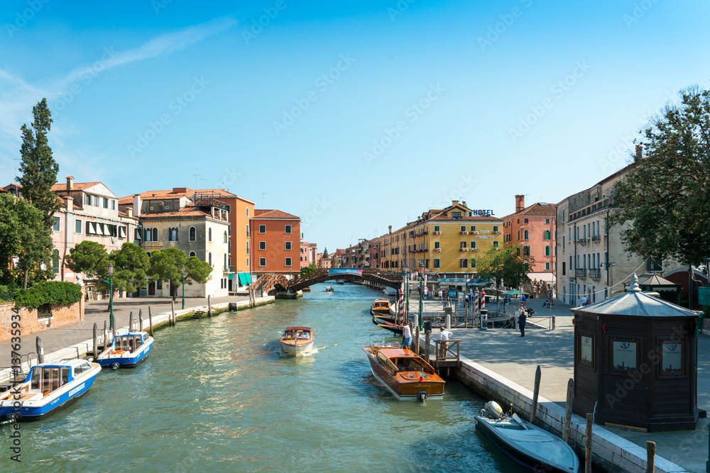 VENICE, ITALY - June 30, 2016. View of water street and old buildings in Venice. its entirety is listed as a World Heritage Site, along with its lagoon.June 30, 2016 VENICE, ITALY