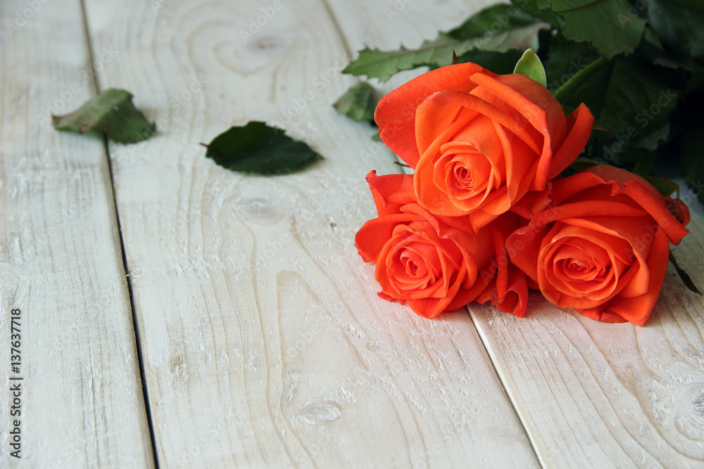 Bouquet of red roses on a wooden background Bouquet of red roses on a wooden background