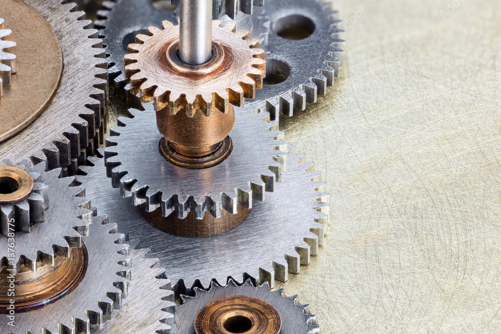 industrial cogwheels on scratched brass background macro view industrial cogwheels on scratched brass background macro view