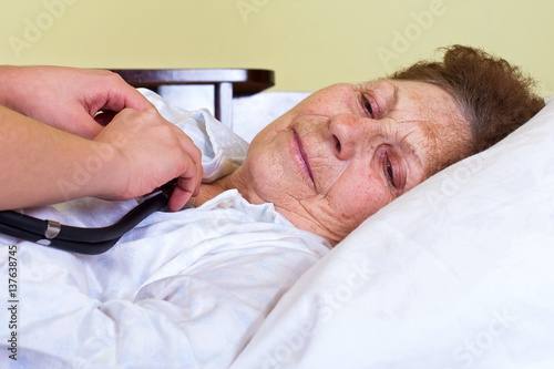 Bilde på lerret Bed ridden elderly woman