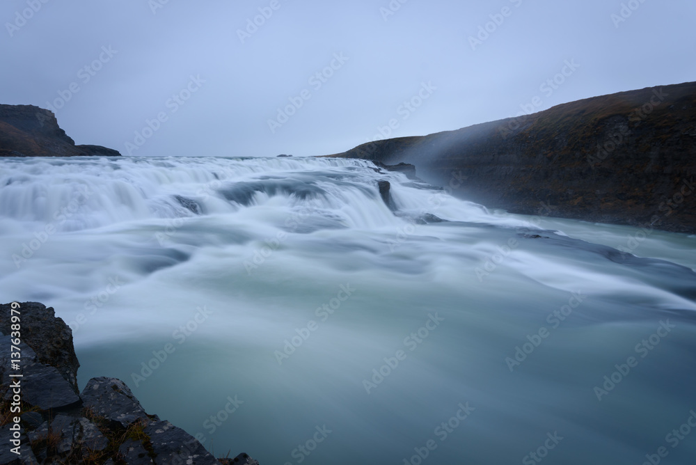 Smooth flowing water of turbulent Gullfoss waterfall