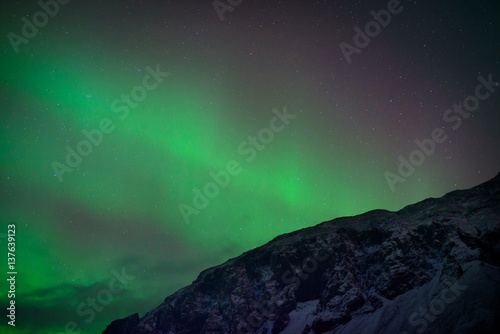 Northern lights over mountains in Iceland © Yohoho