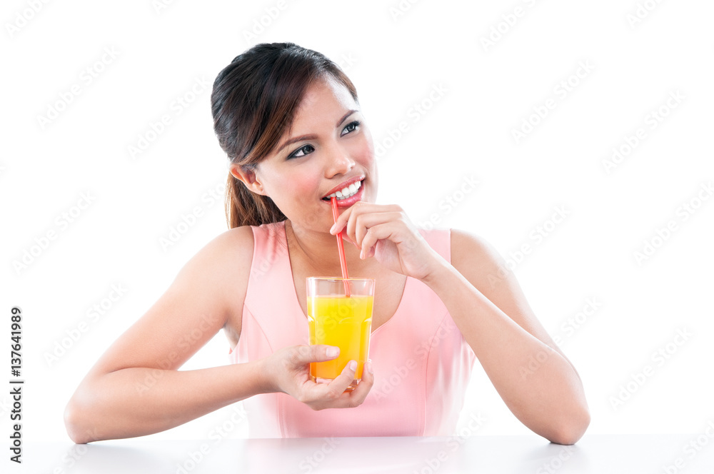 Attractive young asian woman drinking orange juice against white background Attractive young asian woman drinking orange juice against white background