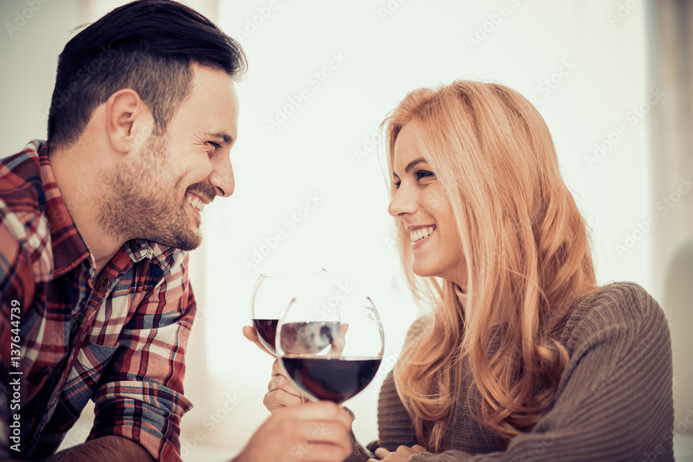 Close up of a young couple enjoying wine at home Close up of a young couple enjoying wine at home