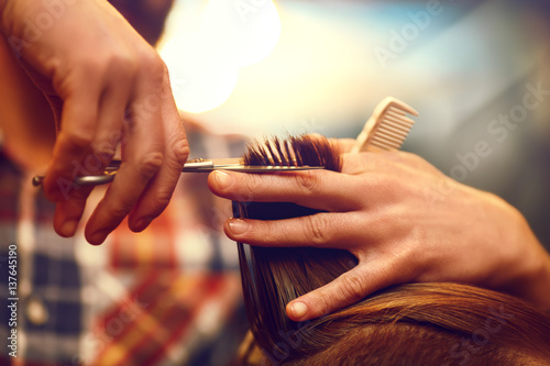 Time for a new hairdo. Handsome young bearded man came to the barber for a haircut. hipster style. the concept of fashion and beauty.