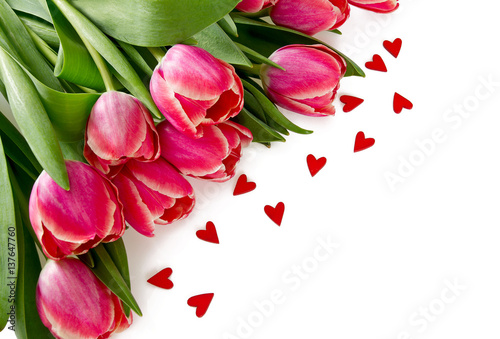 Fototapeta Naklejka Na Ścianę i Meble -  pink tulips and small wooden hearts on white background