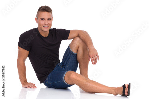 Smiling Casual Man Sitting On Floor