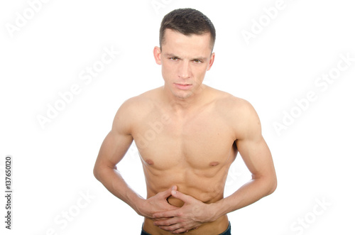 Young man shirtless and abdominal pain. Stomach problems.