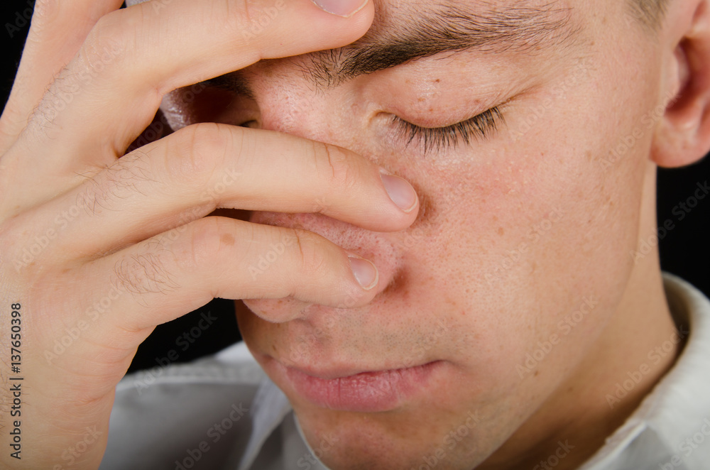 Fototapeta premium Stress and problems. Young man with a headache.