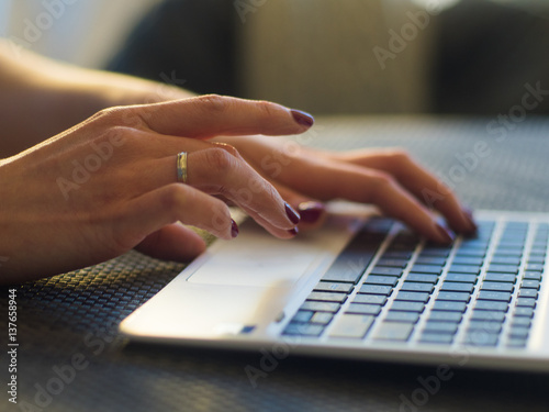 Close Up of woman hands using laptop computer.