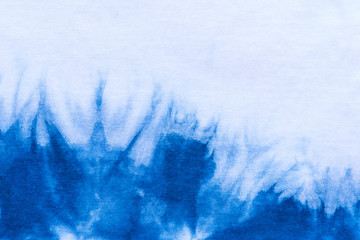 Pattern of blue tie batik dye on cotton cloth, Dyed indigo fabric background and textured, Painted blue watercolor on white cotton cloth