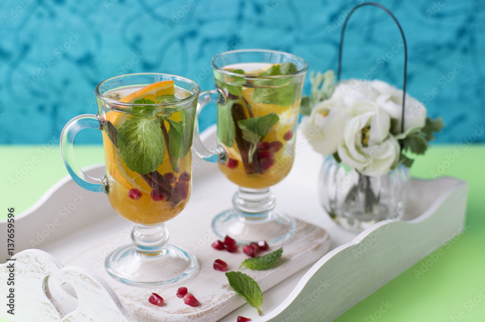 Herbal tea with sliced orange, mint and cinnamon Herbal tea with sliced orange, mint and cinnamon
