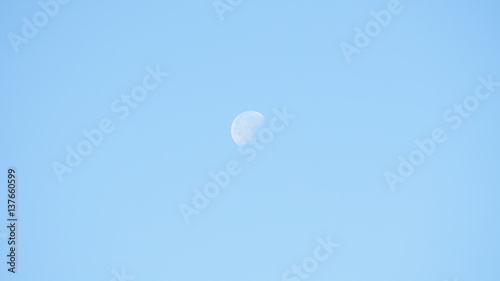 Clear blue sky with a waning gibbous moon