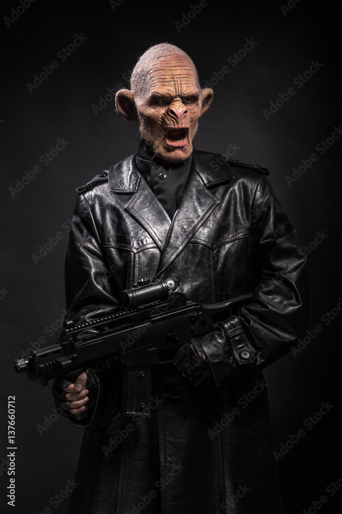 Angry baboonish man in black clothes on dark background Angry baboonish man in black clothes on dark background