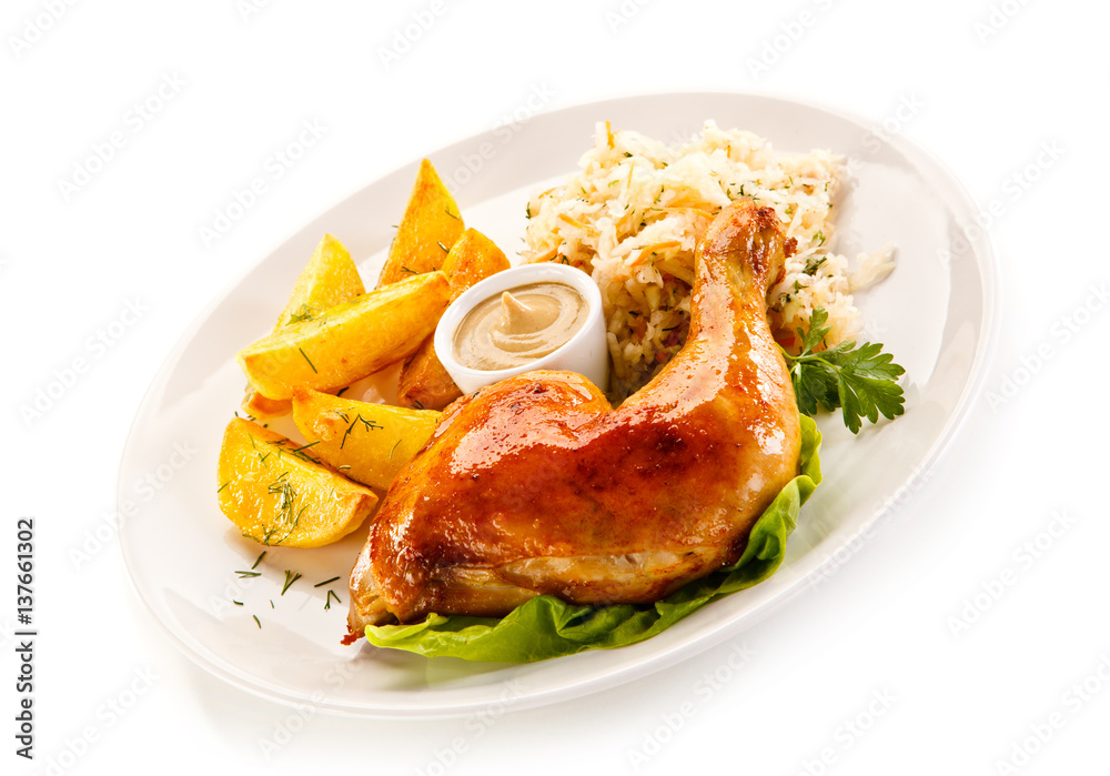 Grilled chicken leg with chips and vegetables on white background Grilled chicken leg with chips and vegetables on white background