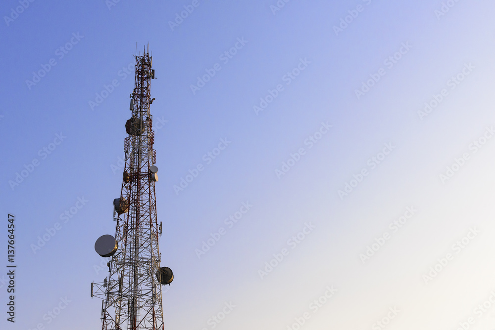 The telecommunication  tower building with the blue sky and morning light