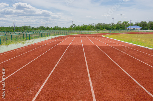 Red Running track with corner of the football field. © lamyai