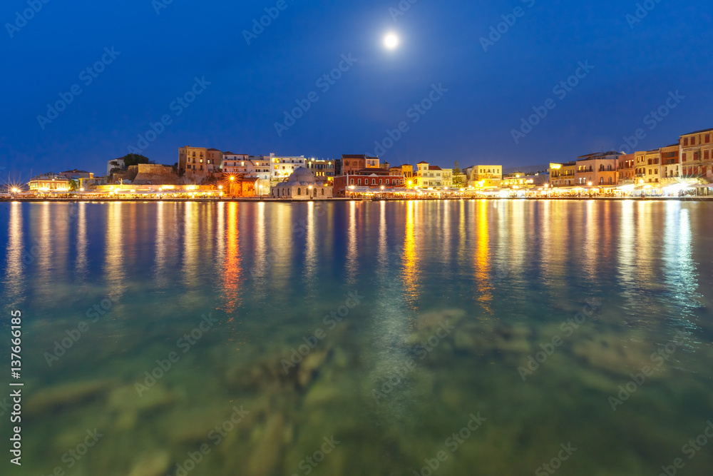 Picturesque view of Venetian quay of Chania with Kucuk Hasan Pasha Mosque at moonlit night, Crete, Greece