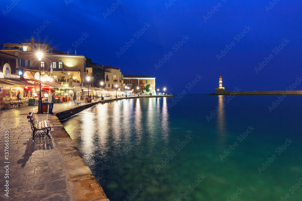 Picturesque view of old harbour with Lighthouse of Chania during twilight blue hour, Crete, Greece