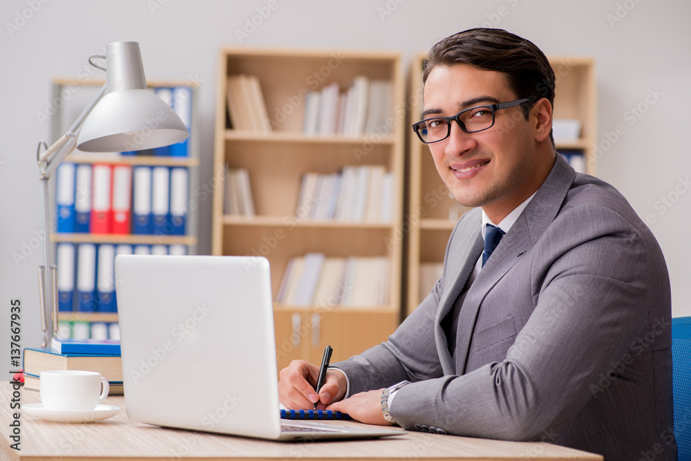 Young handsome businessman working on office Young handsome businessman working on office