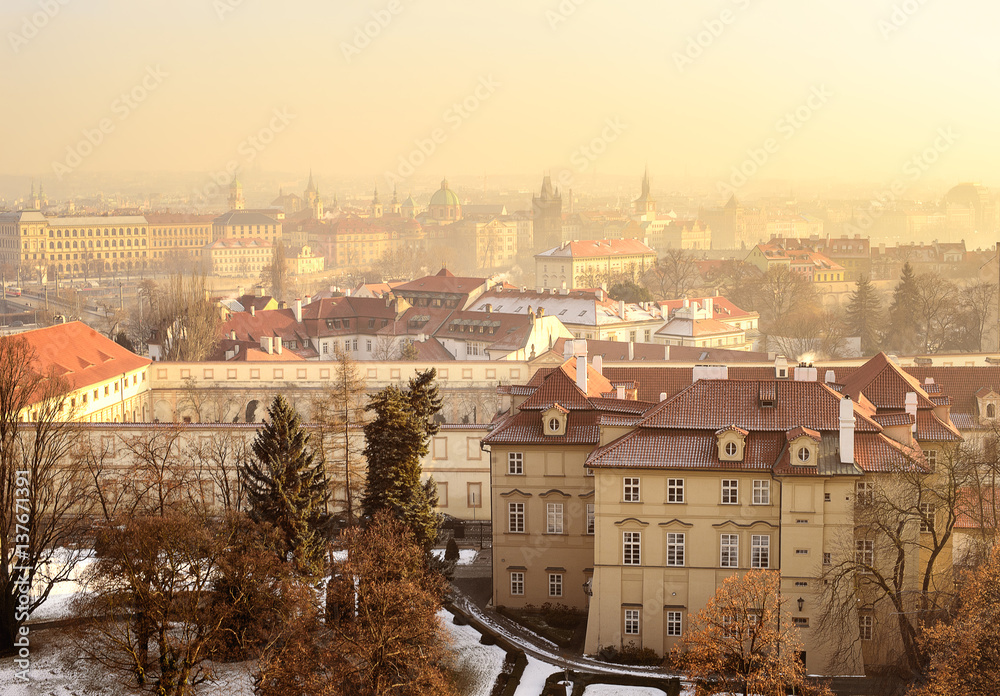 Aerial view to Prague's buildings and the city from Prague Castle on a foggy day.