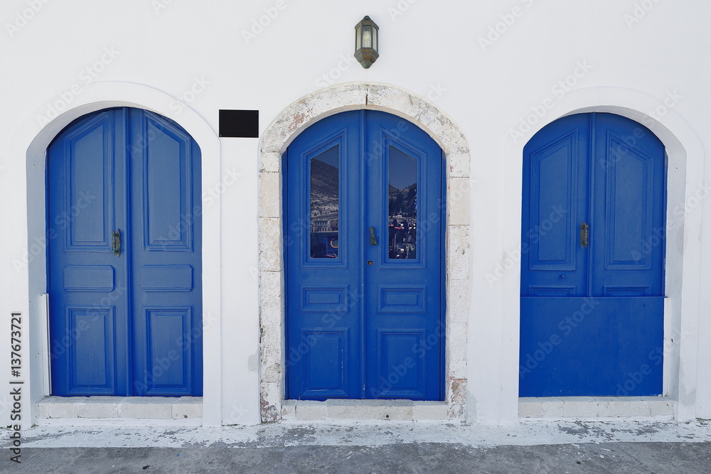 Blue doors of waterfront restored house-central main harbor. Kastellorizo-Greece. 1699