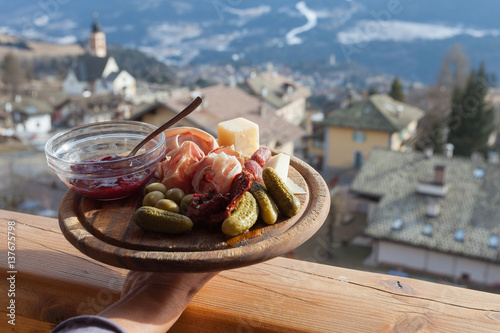 Mountain wooden plate of italian lunch, Fiemme Valley, Trentino, Italy