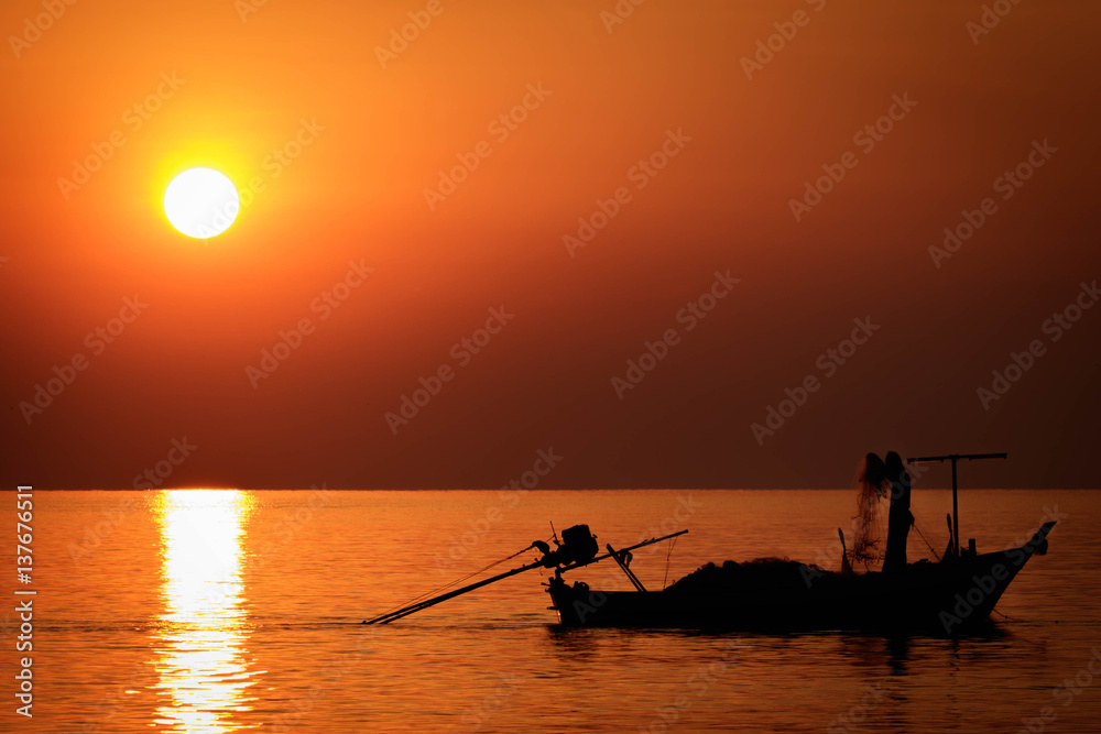 Silhouette fishing boat in the sea at sunrise landscape