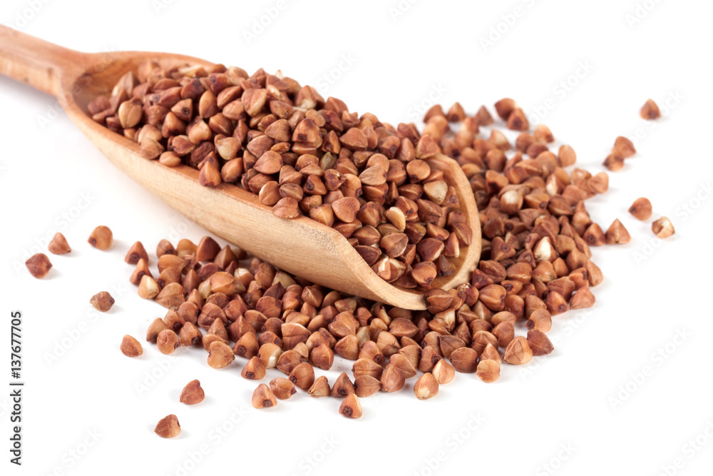 buckwheat in the wooden scoop isolated on white background buckwheat in the wooden scoop isolated on white background