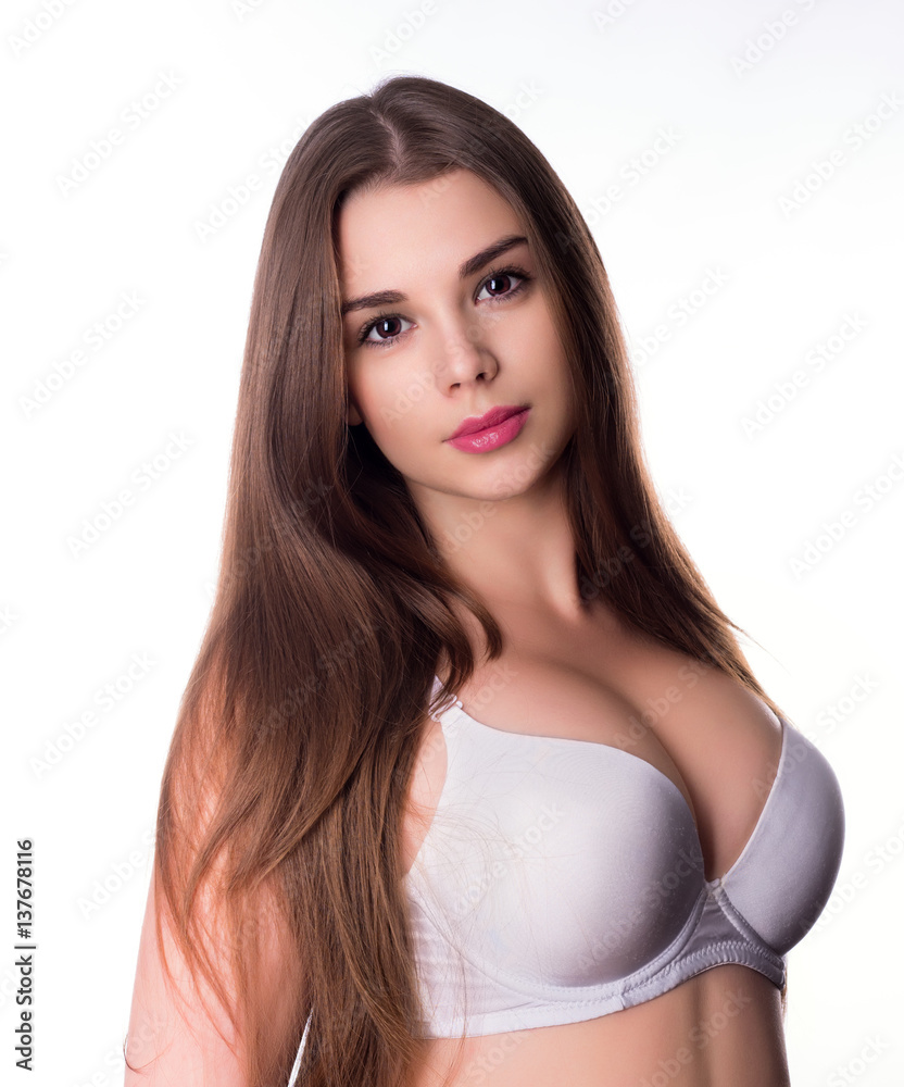 Brunette with big breasts posing in sexy bra Stock Photo | Adobe Stock