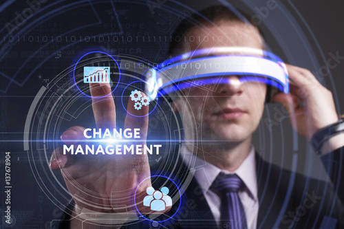 Business, Technology, Internet and network concept. Young businessman working in virtual reality glasses sees the inscription: Change management