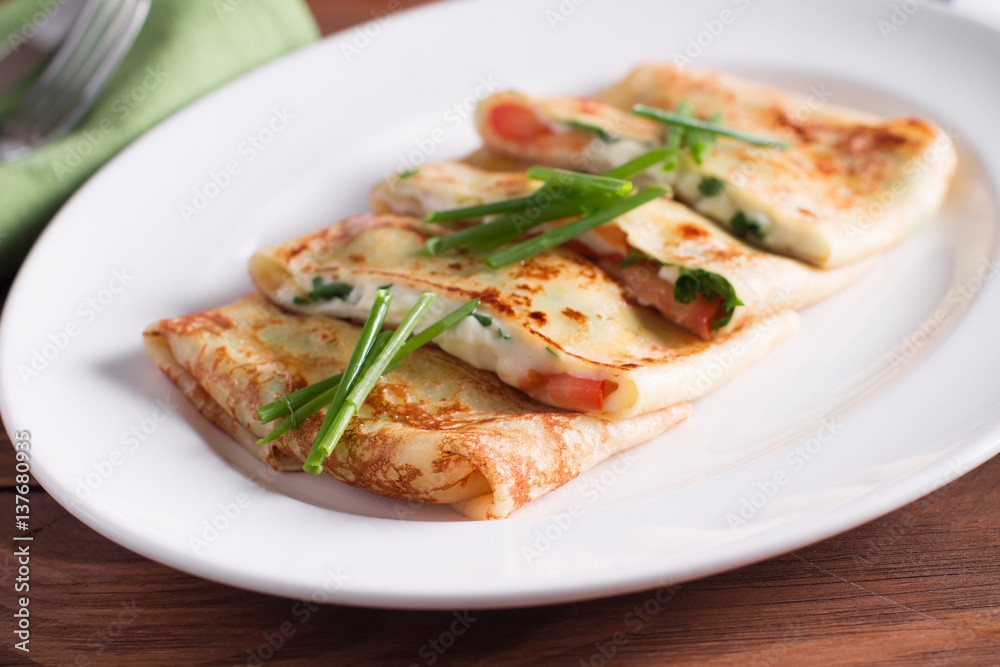 Healthy Breakfast crepes with bacon, cheese, greens, tomatoes on a wooden table. Selective focus Healthy Breakfast crepes with bacon, cheese, greens, tomatoes on a wooden table. Selective focus