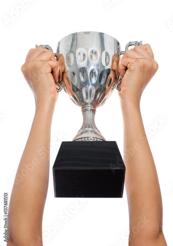 Woman two hand holding a champion silver trophy on white background