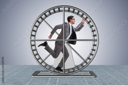 Businessman running on hamster wheel