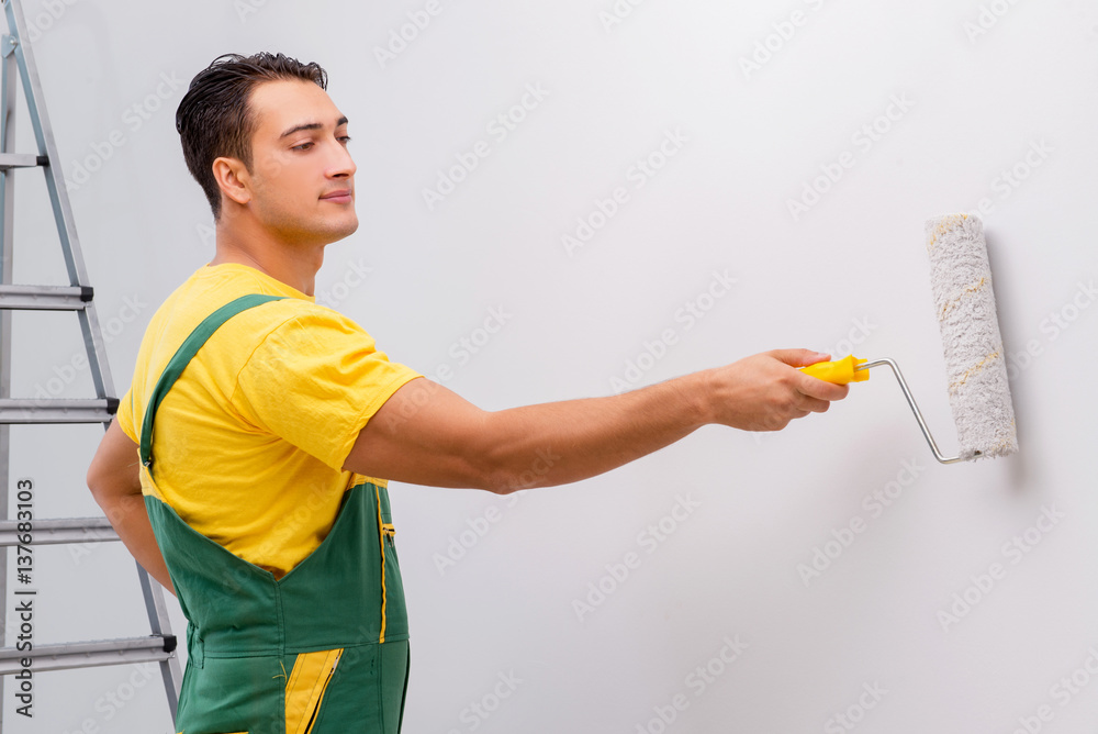 Man painting the wall in DIY concept Man painting the wall in DIY concept